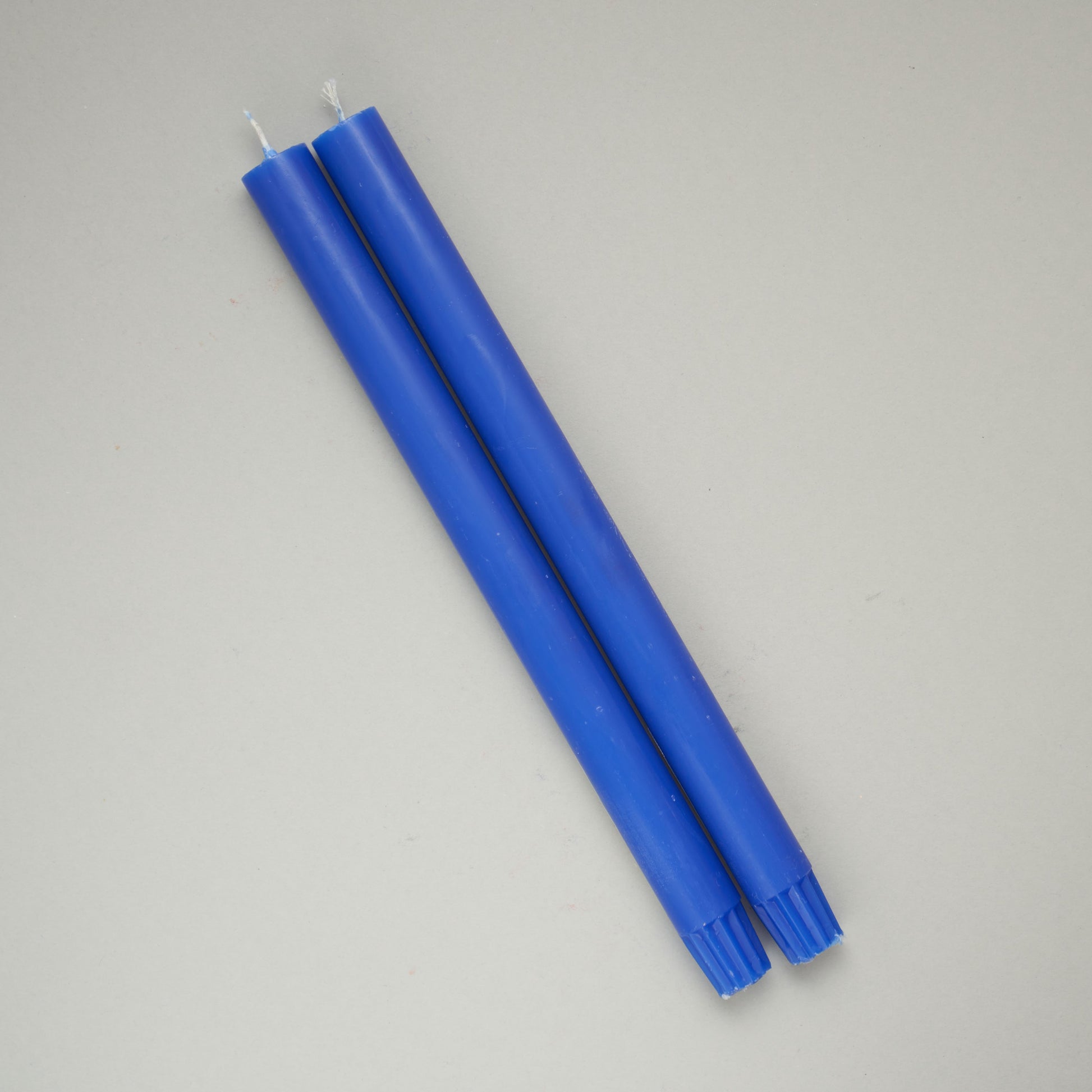 Two cobalt blue dinner candles from True Grace