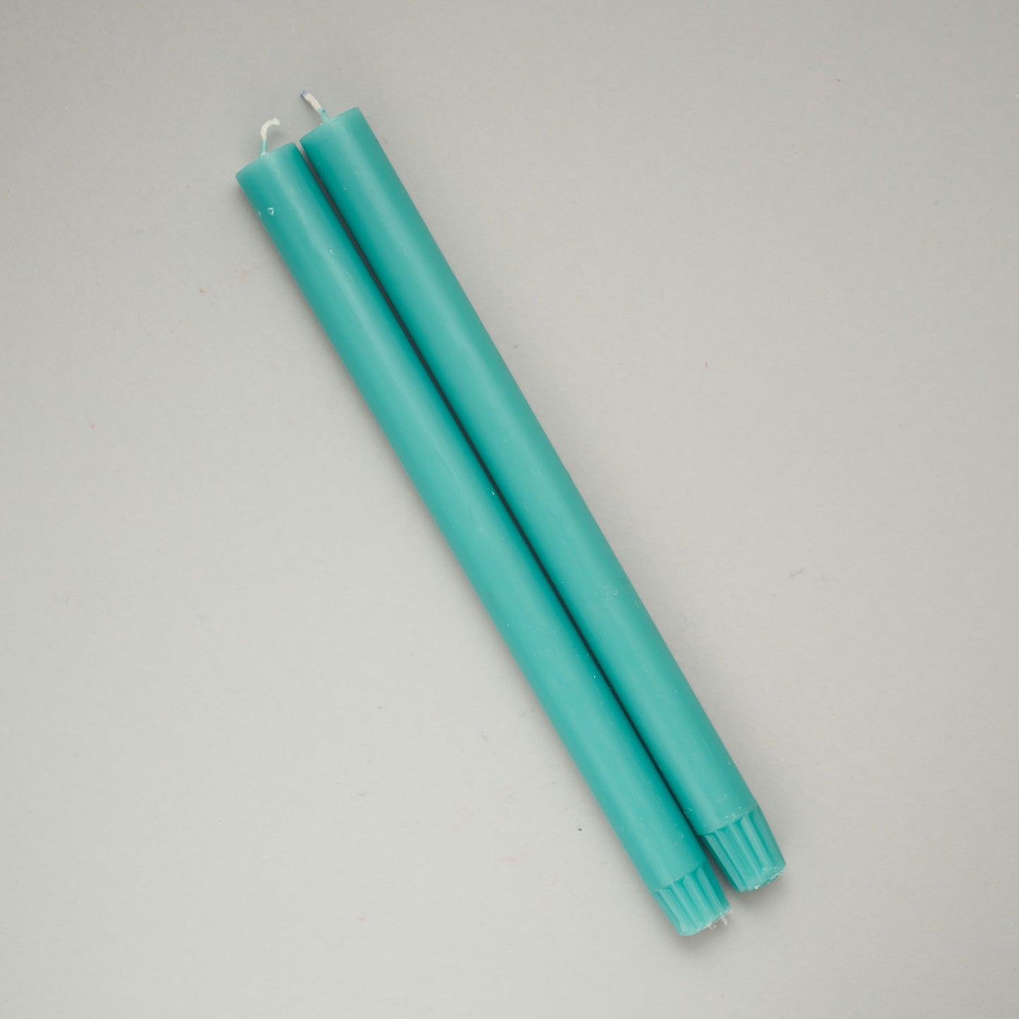 Two turquoise dinner candles from True Grace