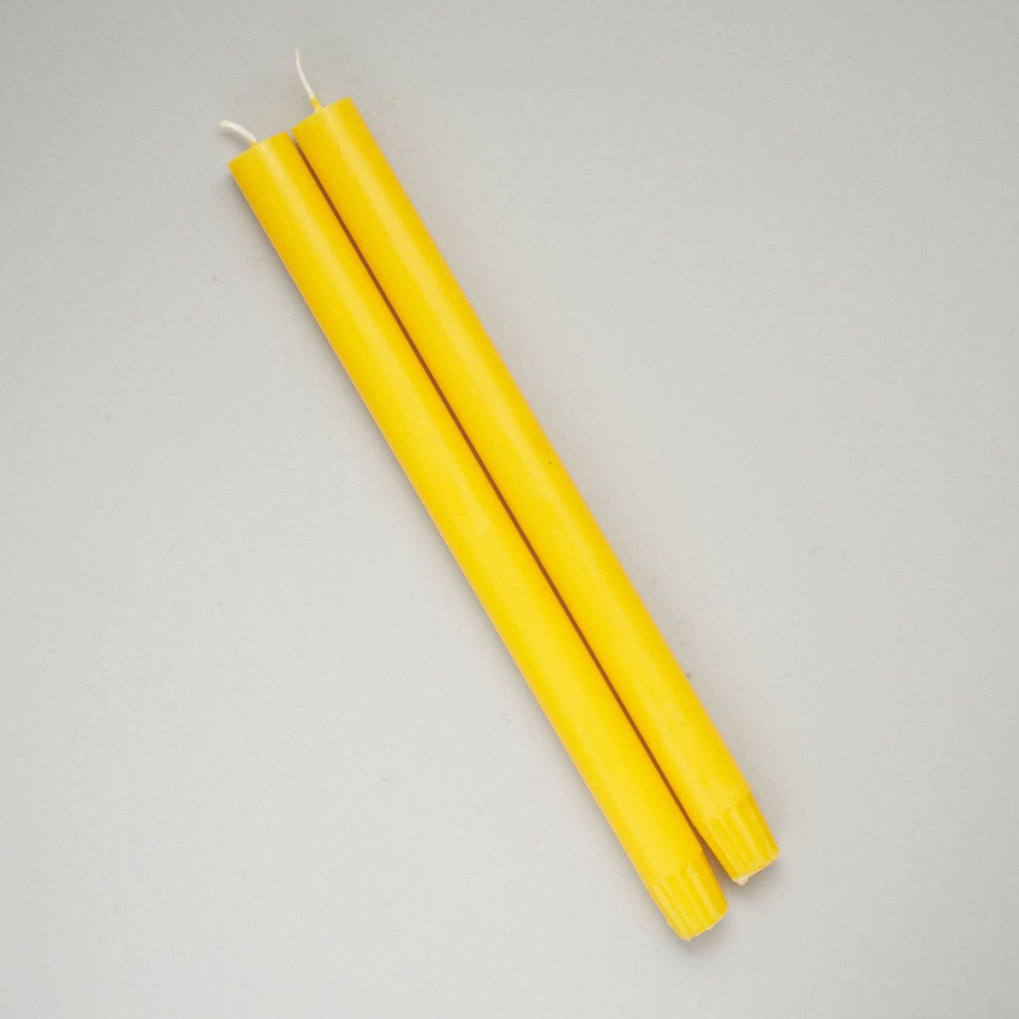 two yellow dinner candles from True Grace