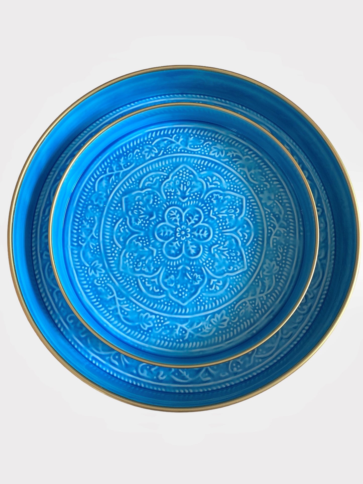 A nest of bright blue enamel trays