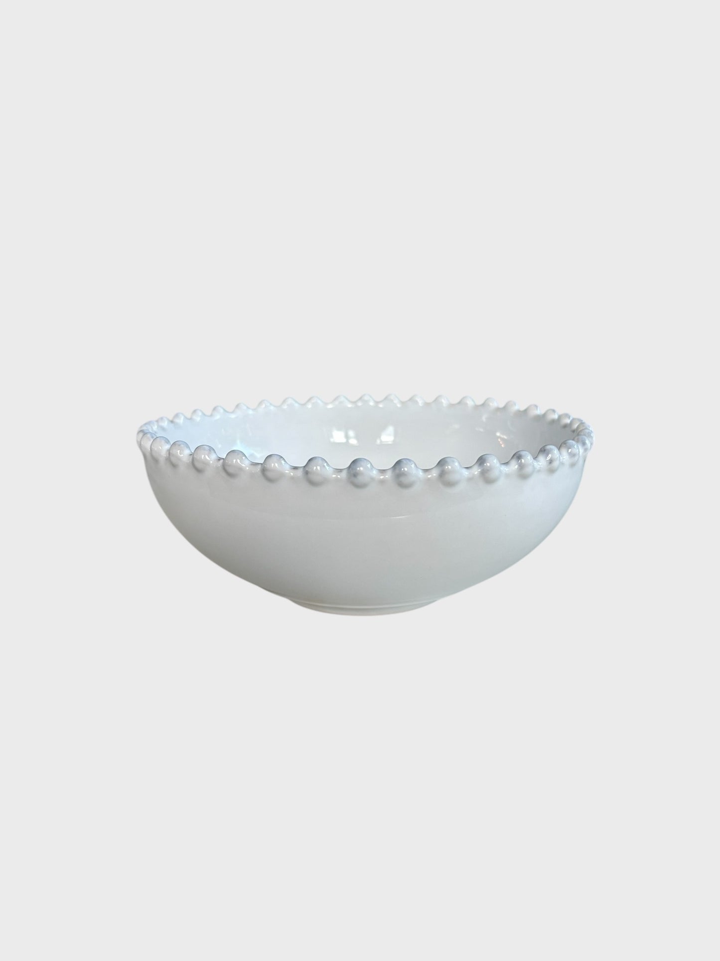 A small white bowl with a beaded edge design