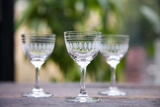 Three crystal liquer glasses with an engraved ovals pattern.
