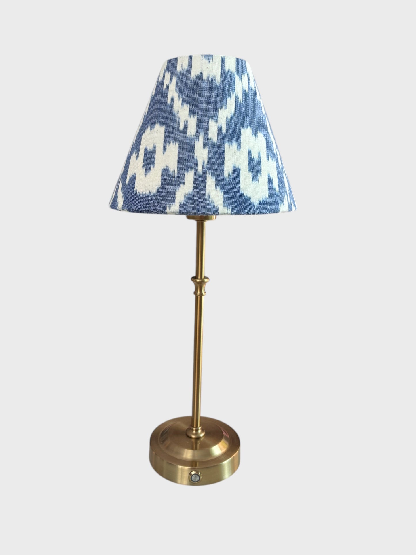 A cordless, rechargeable lamp with a handmade ikat shade