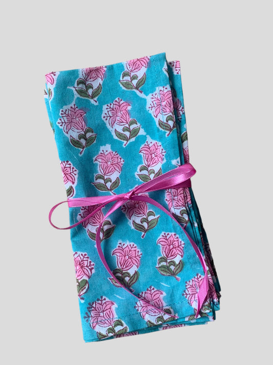 a set of 4 turquoise and pink floral block printed napkins tied with ribbon