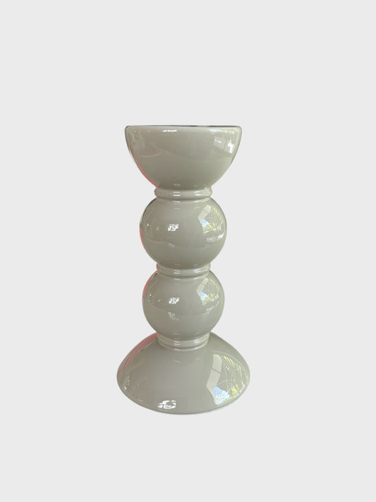 A short bobbin shaped candlestick in cappuccino colour