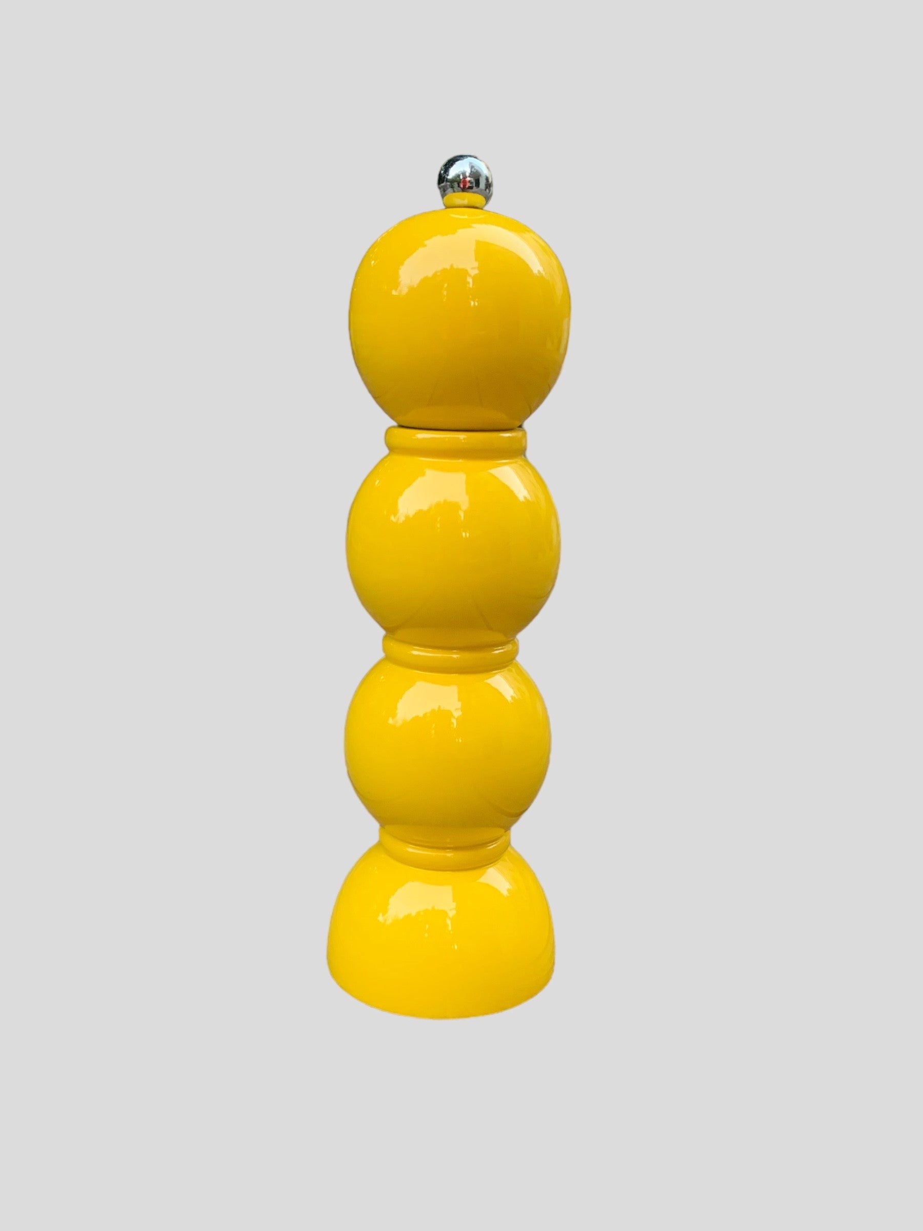 A yellow bobbin shaped salt grinder from Addison Ross