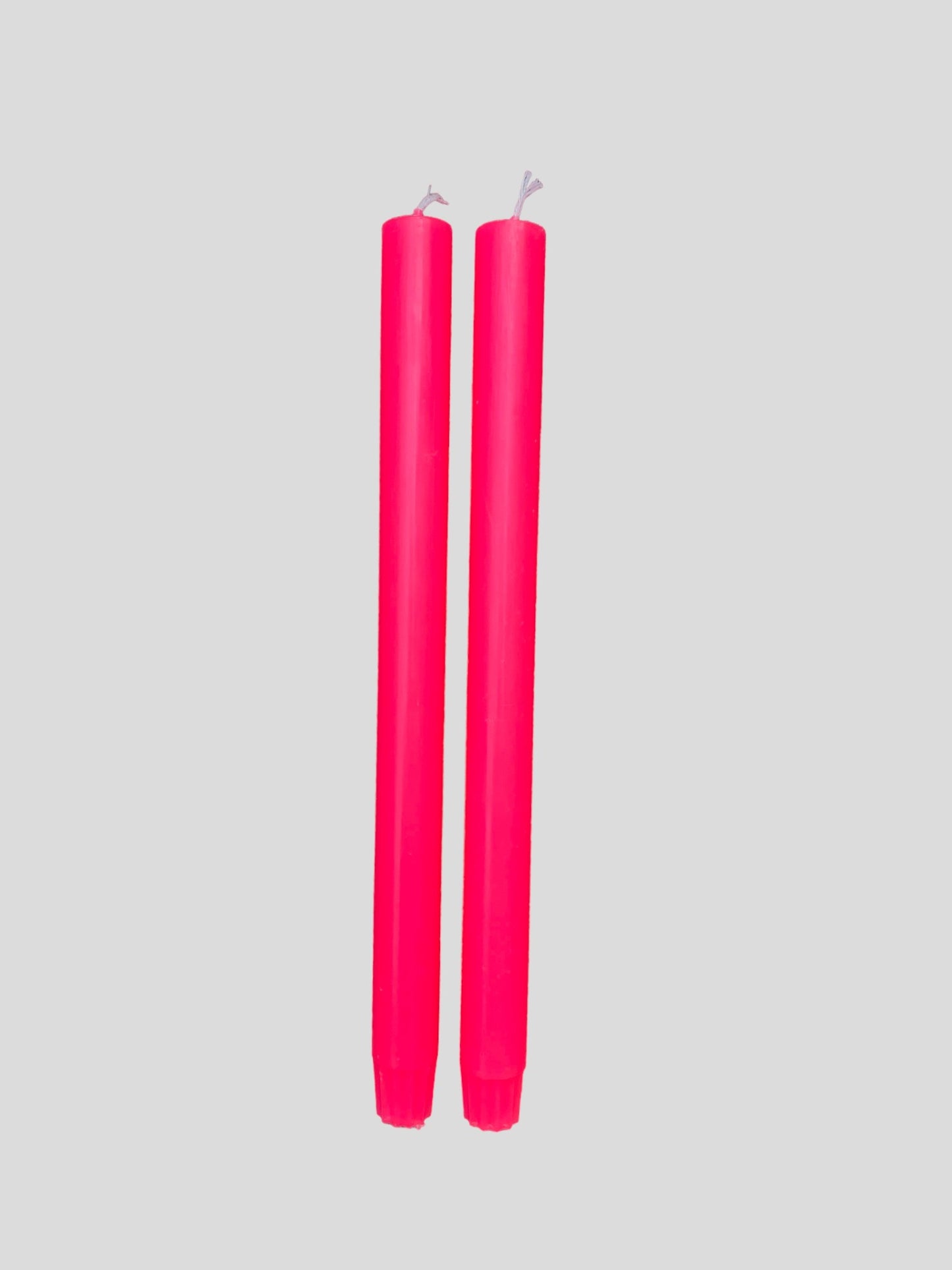 A pair of fluorescent pink candles from True Grace