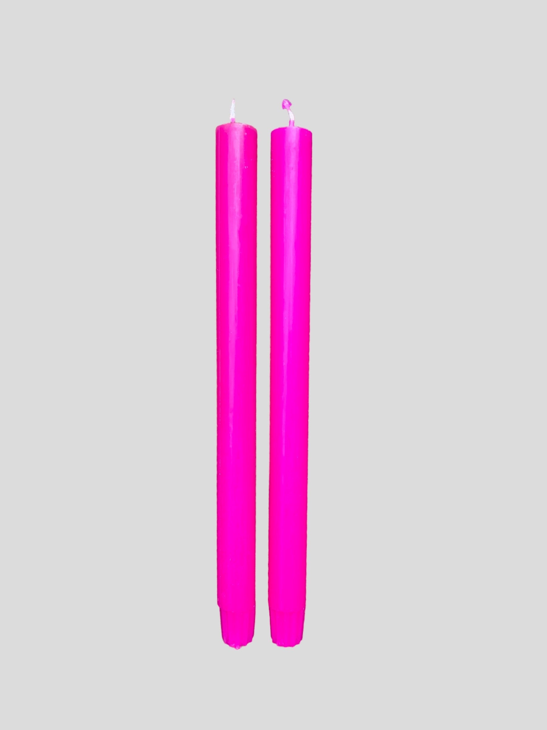 A pair of fluorescent purple candles from True Grace