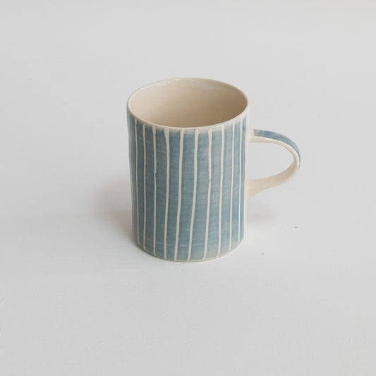 A hand-painted mug in dove grey with white stripes.  Made in Portugal.