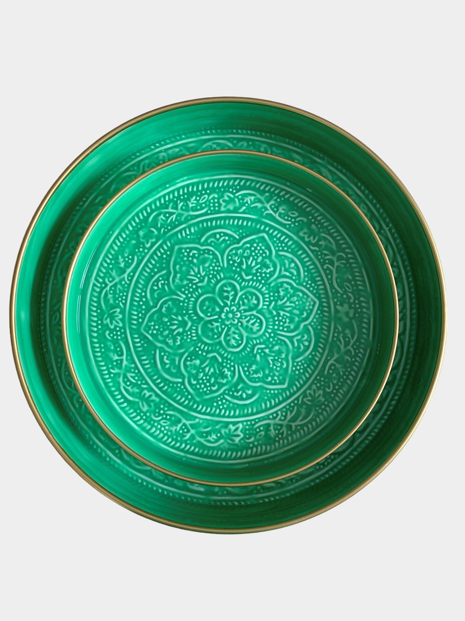 A medium sized green enamel tray sitting inside a larger sized green enamel tray.