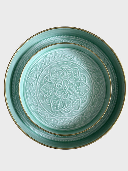 A set of 2 enamel trays in a duck egg blue colour.  The trays are handmade with floral embossing detail.
