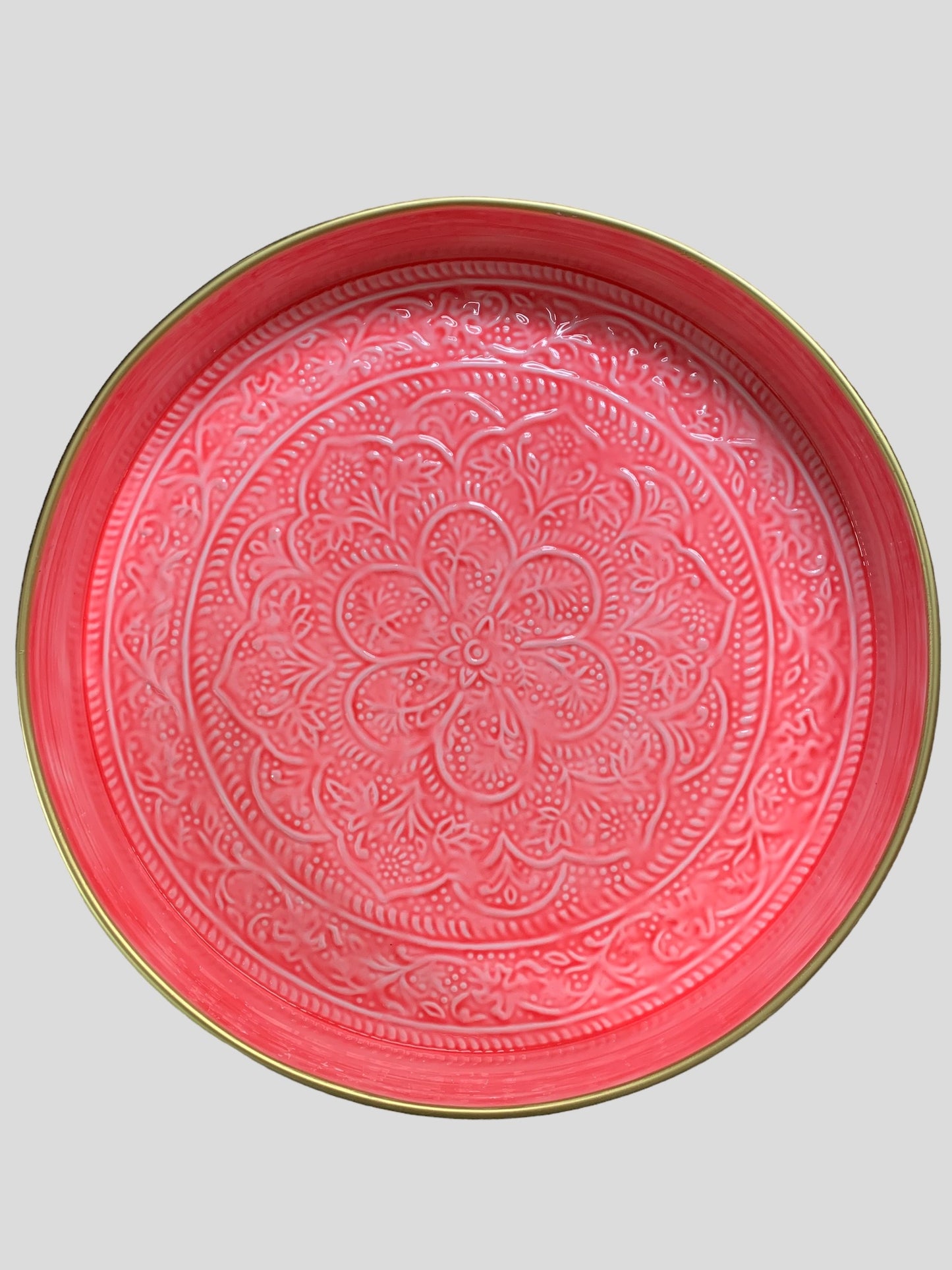 A large enamel tray in a bright pink colour with a floral pattern.