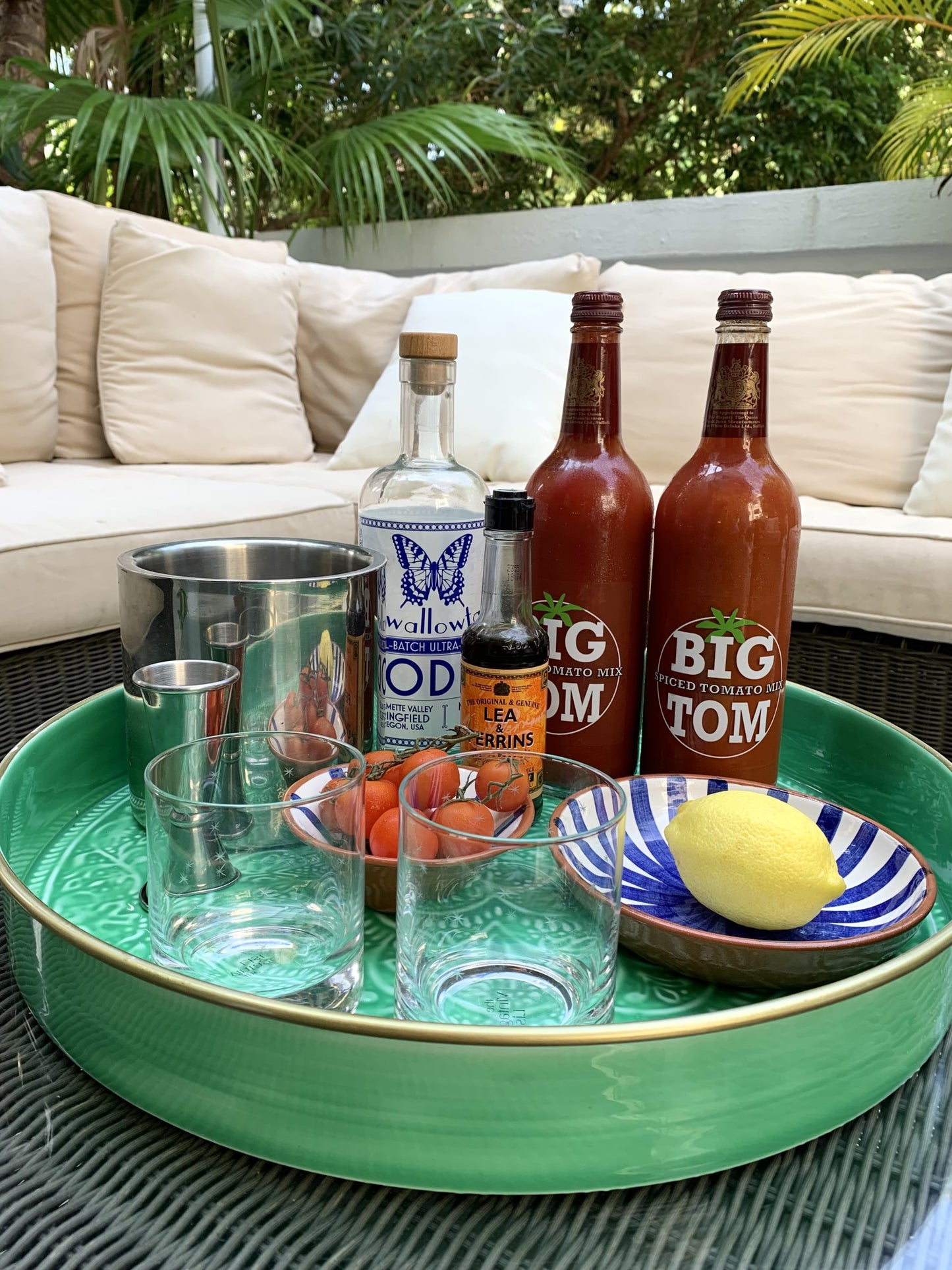 A large green enamel tray being used as a drinks tray for bloody marys.