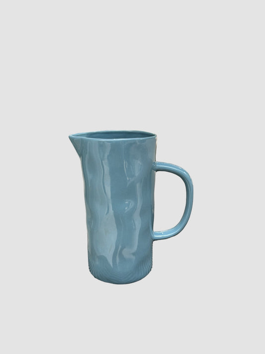 A medium sized handmade jug in a blue colour