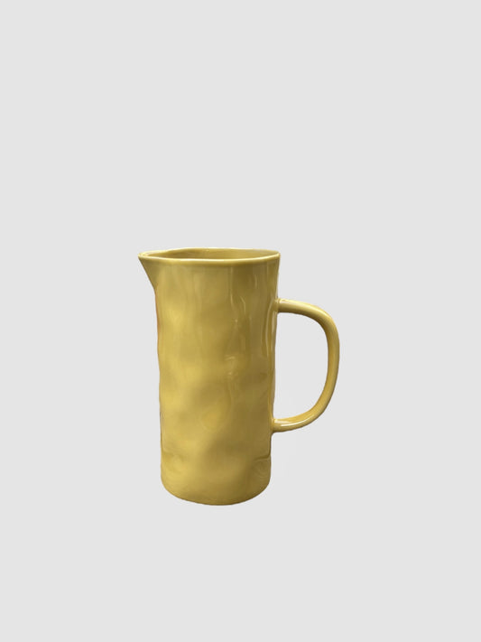A handmade yellow jug