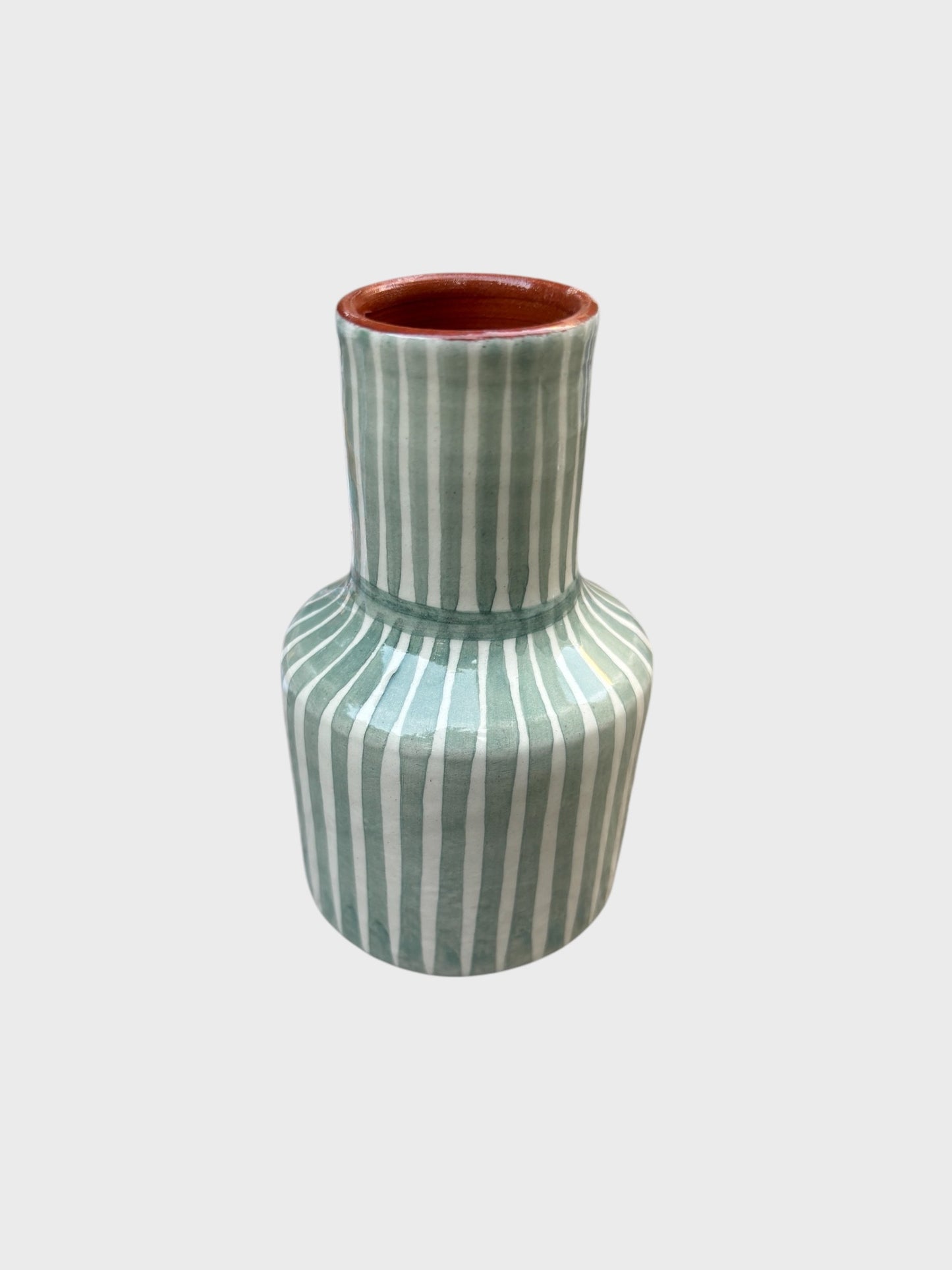 A mini sage and white striped vase from casa cubista