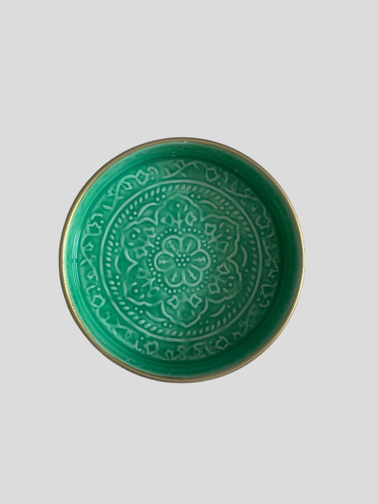 A mini green enamel tray with floral embossing detail.