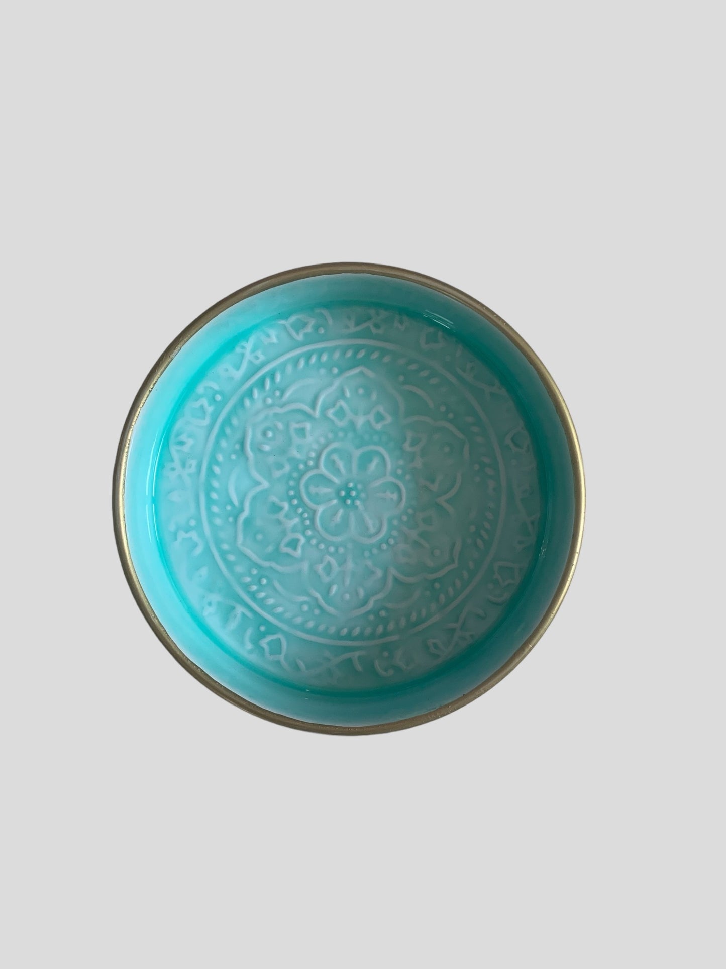 A mini light blue enamel tray with floral embossing detail.