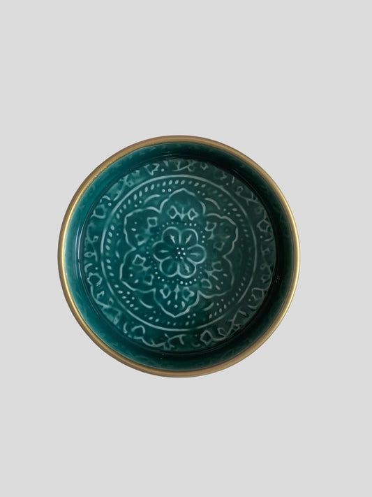 A mini teal enamel tray with floral embossing detail.