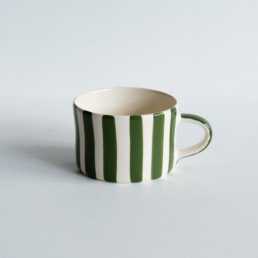 A wide, short mug with hand-painted green stripes.