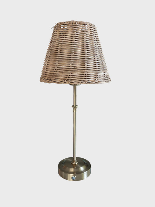 A cordless lamp with a rattan shade
