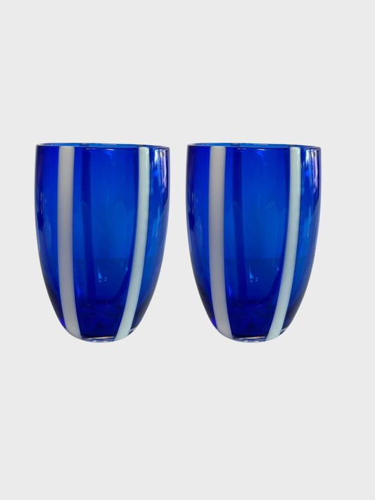 A pair of blue and white striped glass tumblers