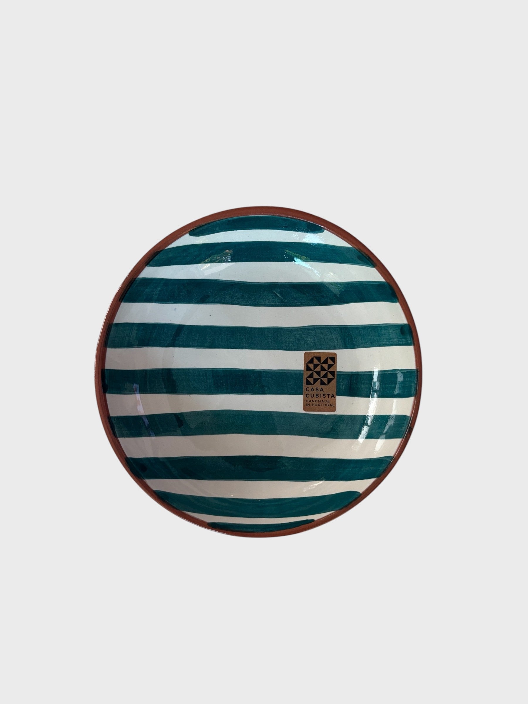 A small hand-painted bowl with teal and white stripes.