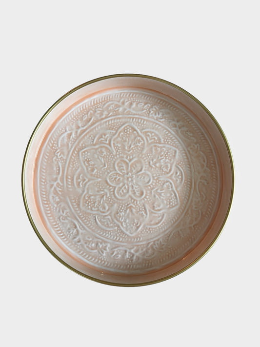 A light pink enamel tray with floral embossed detail.