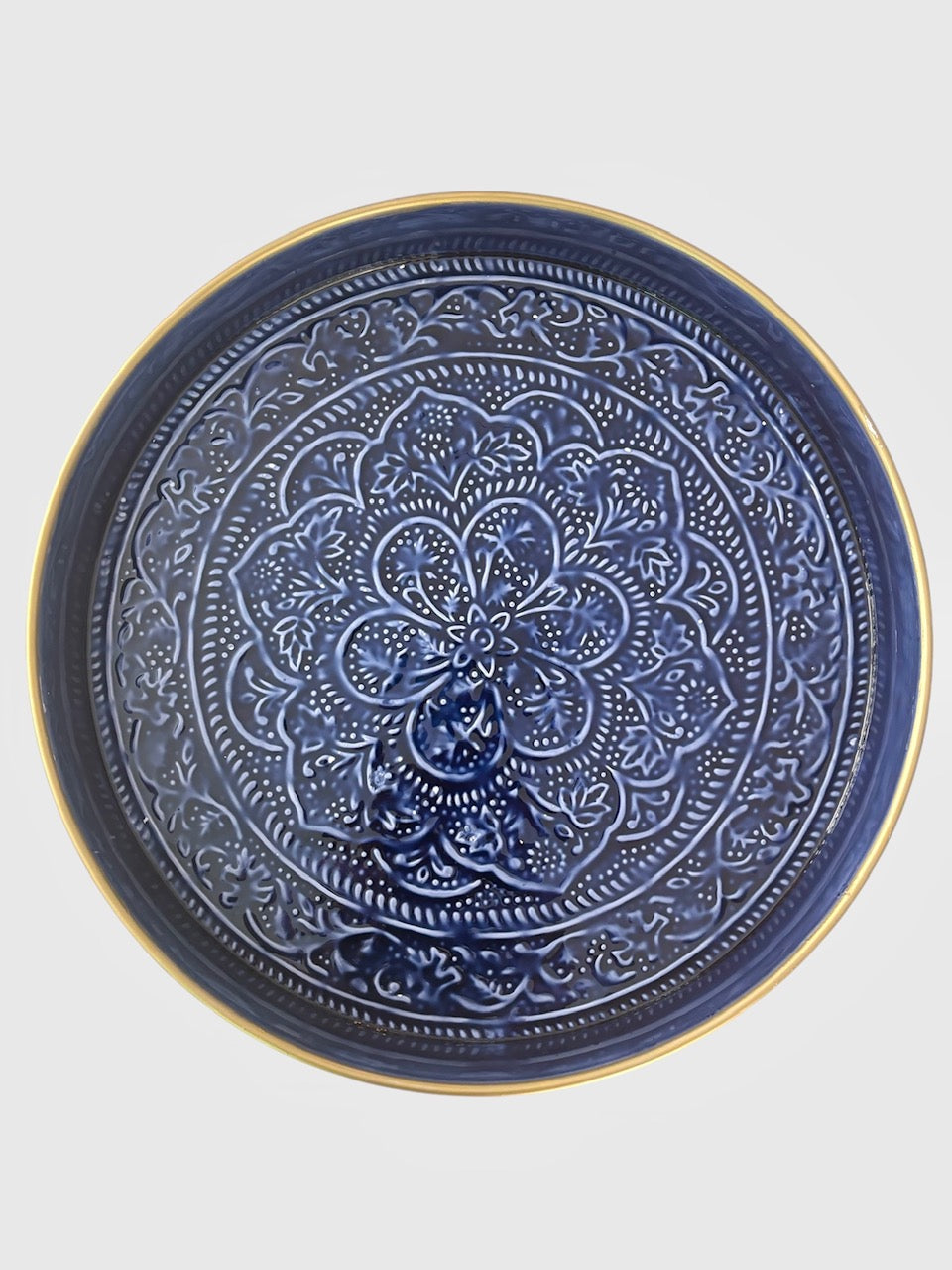 A large sapphire blue tray with an embossed floral design