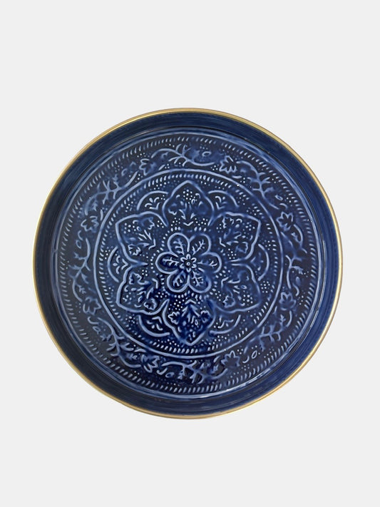 A sapphire blue tray with an embossed floral design.