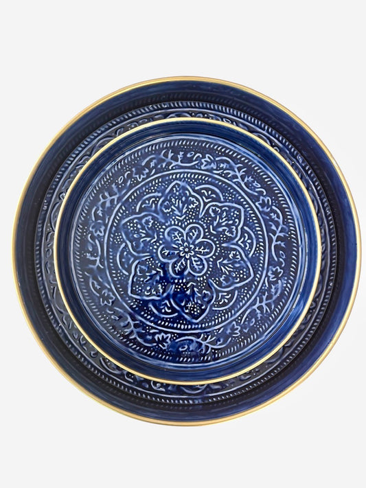 A set of 2 sapphire blue enamel trays with hand embossed floral pattern.