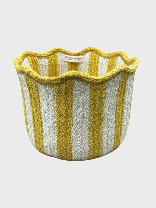 A jute tulip basket with yellow stripes and scalloped edging