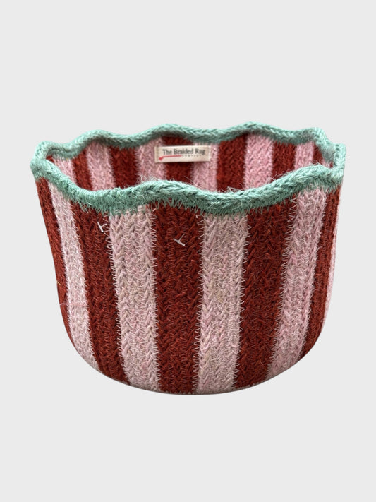 A red and pink striped tulip basket with pale blue scalloped edging