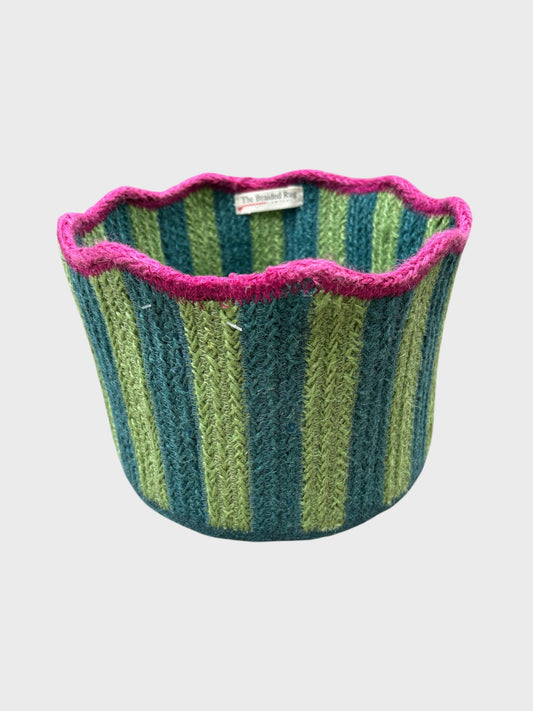 A green & blue striped tulip basket with pink scalloped edging