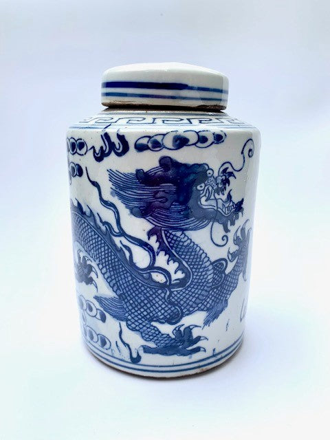 A ceramic blue and white tea jar (ginger jar) with a dragon on it.