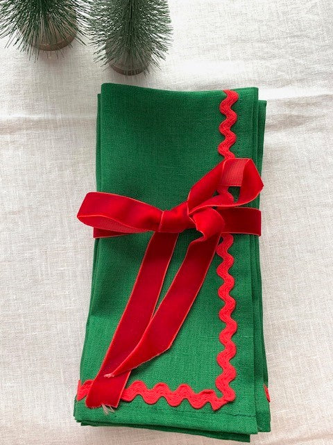 Christmas linen napkins tied together with red velvet ribbon.