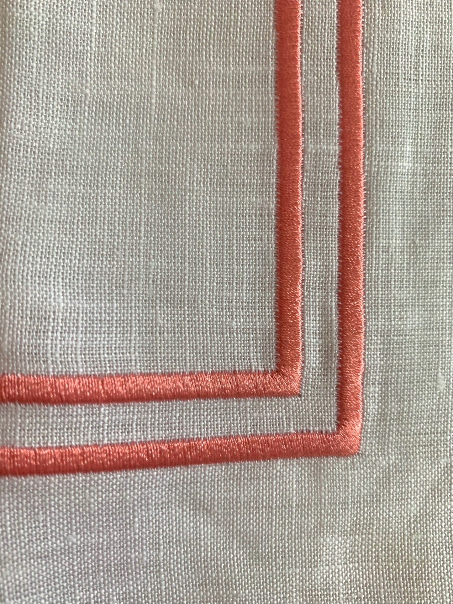 double edged piping in coral on white linen